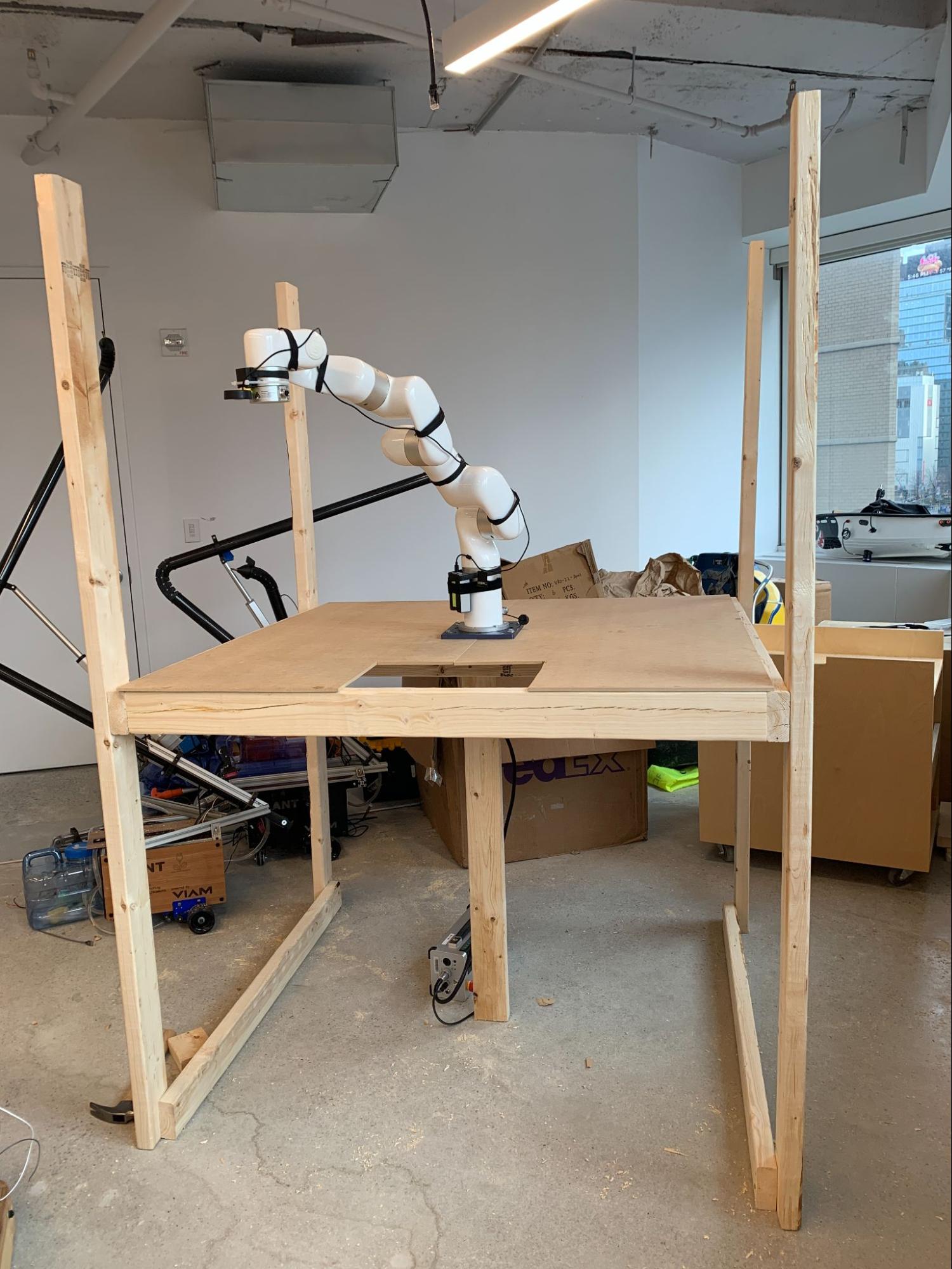 The xarm6 attached to the middle of the enclosure.